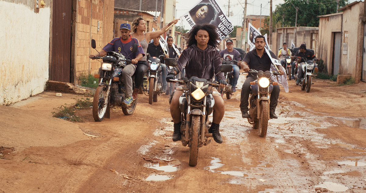 Still from "Dry Ground Burning," A film by Joana Pimenta and Adirley Queirós (Brazilians riding biks through favela)