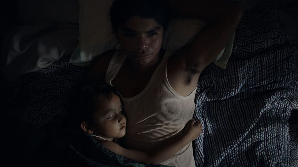 Four-year-old Sujo sleeping with his father