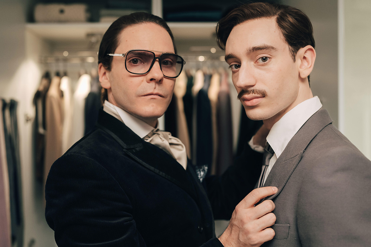 Becoming Karl Lagerfeld -- Season 1 -- In 1972, Karl Lagerfeld (Daniel Brühl) is 38 and not yet wearing his iconic hairstyle. He is a ready-to-wear designer, unknown to the general public. While he meets and falls in love with the sultry Jacques de Bascher (Théodore Pellerin), an ambitious and troubling young dandy, the most mysterious of fashion designers dares to take on his friend (and rival) Yves Saint Laurent (Arnaud Valois), a genius of haute couture backed by the redoubtable businessman Pierre Bergé (Alex Lutz). "Becoming Karl Lagerfeld" plunges us into the heart of the 70s, in Paris, Monaco and Rome, to follow the formidable blossoming of this complex and iconic personality of Parisian couture, already driven by the ambition to become the Emperor of fashion. (Courtesy of Caroline Dubois, Jour Premier/Disney) DANIEL BRÜHL, THÉODORE PELLERIN